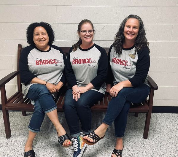 Laura Ross, Eliza Boyce, & Jenny Chapman sitting on a bench at Five Forks Middle School